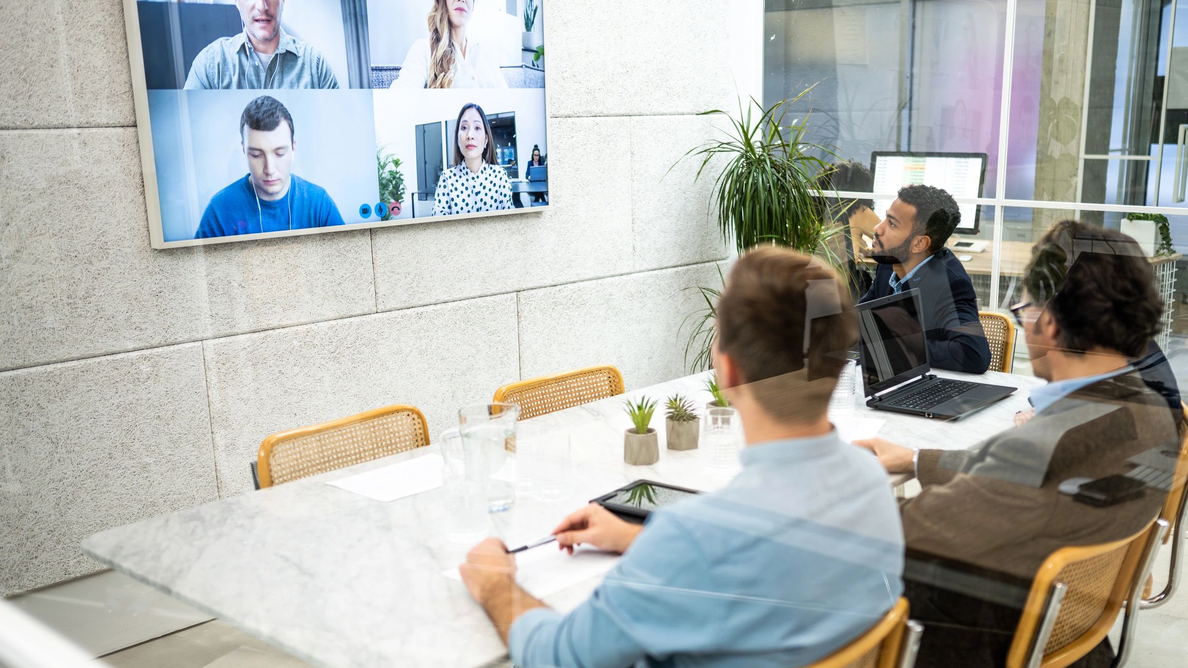 Business owner collaborating with a remote team on a video conference