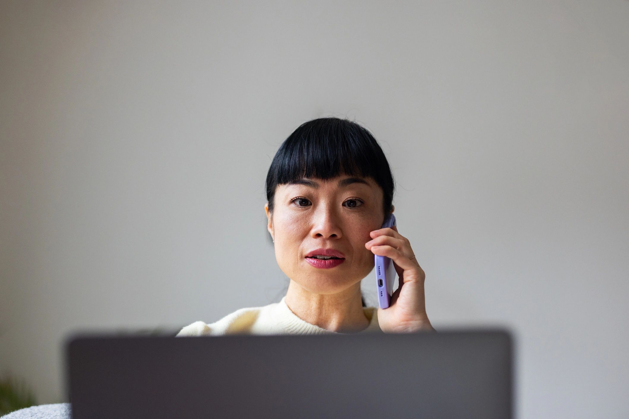 Support specialist speaking on a headset next to a laptop